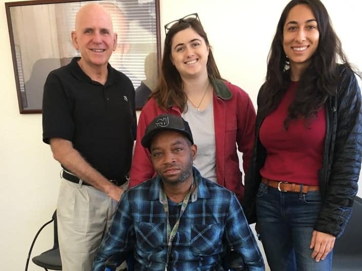 Photo courtesy of the Patch. Bob Shea (left), along with Paula and Ryann of North Side Housing, recently helped Teddy replace his broken wheelchair with one that is fully functional, for free. Teddy is a double amputee who had been using a wheelchair that was held together with tape.