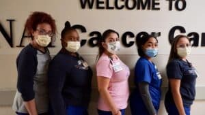 Supportive Oncology team workers at Sinai Chicago pose as a group wearing masks.